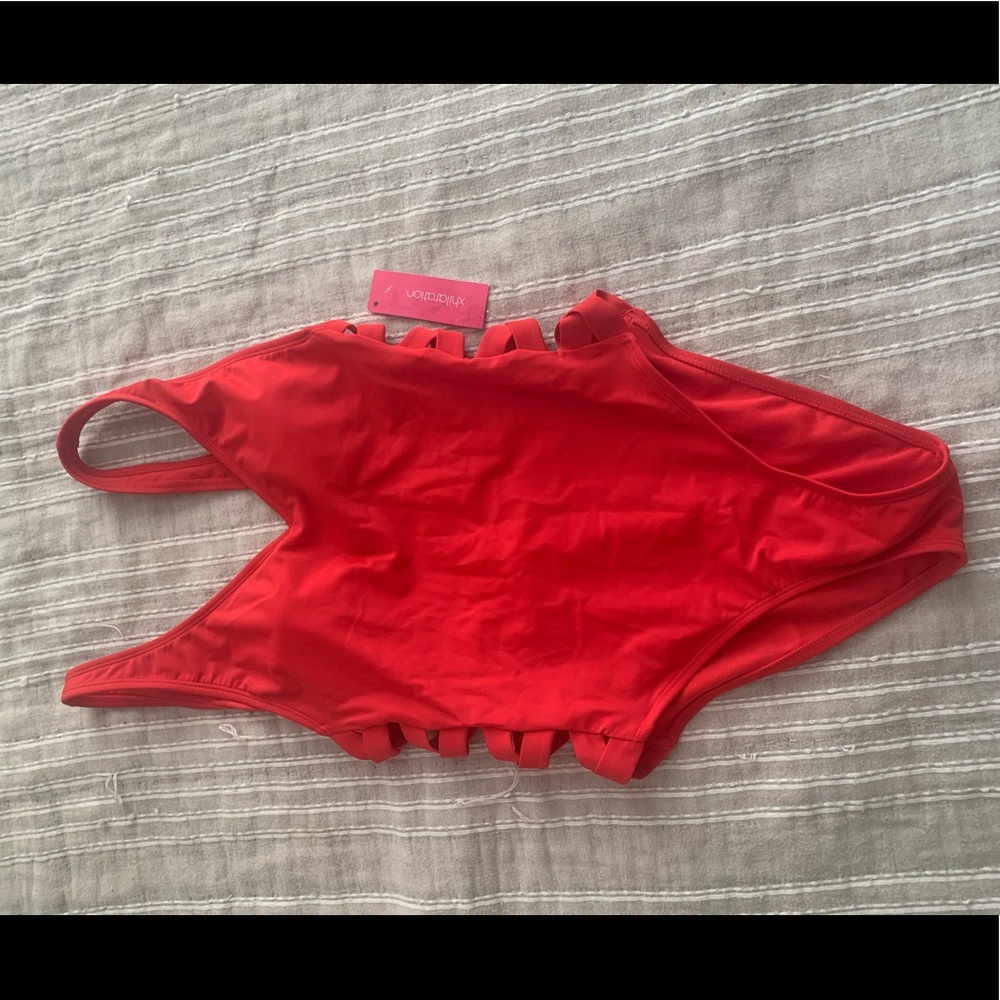 Red one piece with side cutouts